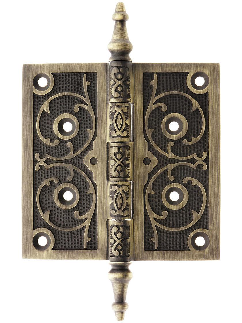 4 1/2 inch Solid Brass Steeple Tip Hinge With Decorative Vine Pattern in Antique Brass.